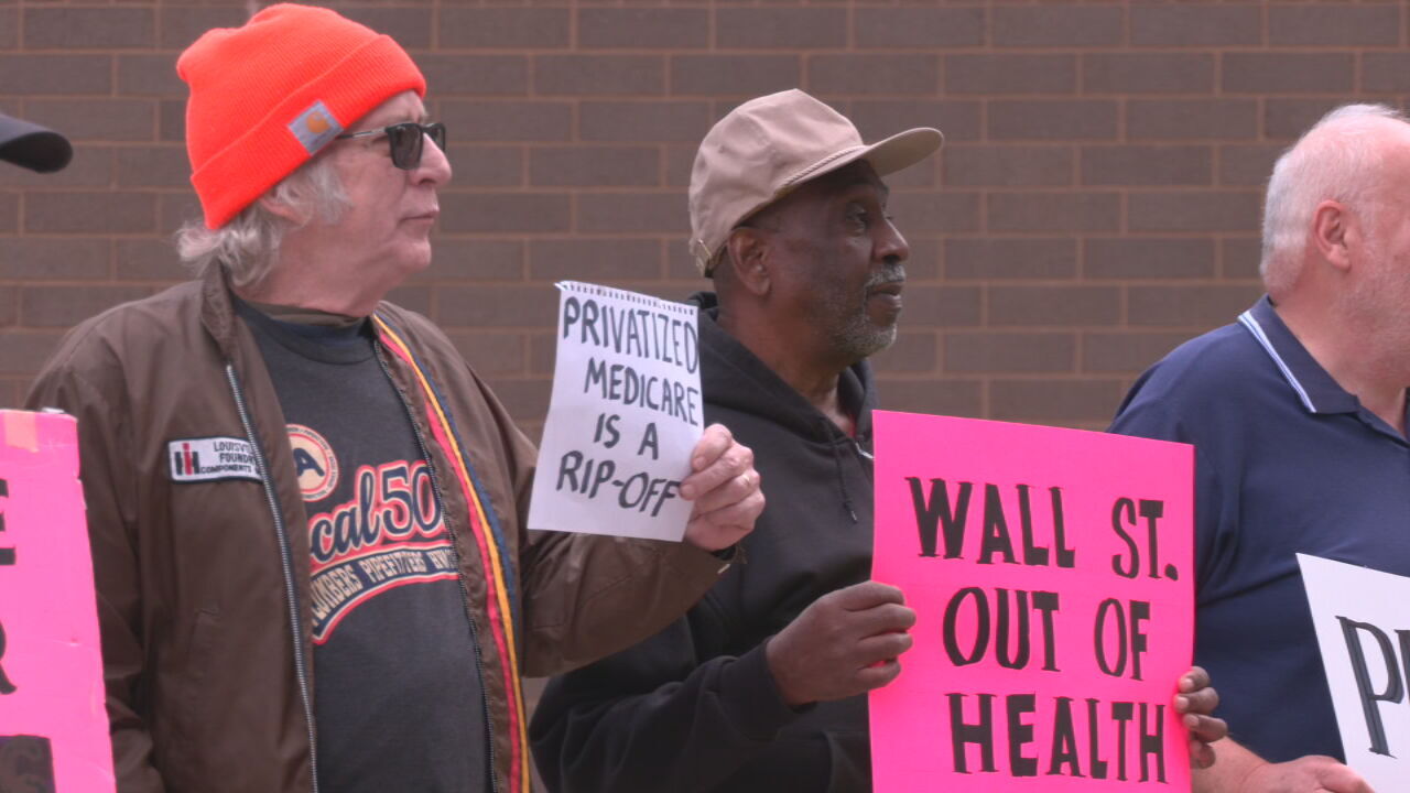 People protest in downtown Louisville outside of Humana for better health care